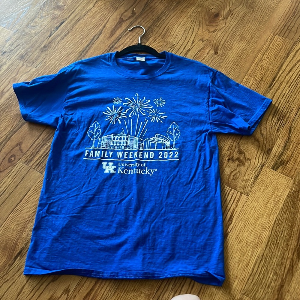 Color is a darker blue, but not yet navy, with white on the front. Never worn!